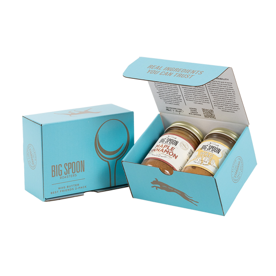Light blue gift box with two jars of Big Spoon Roasters nut butter next to a closed blue gift box