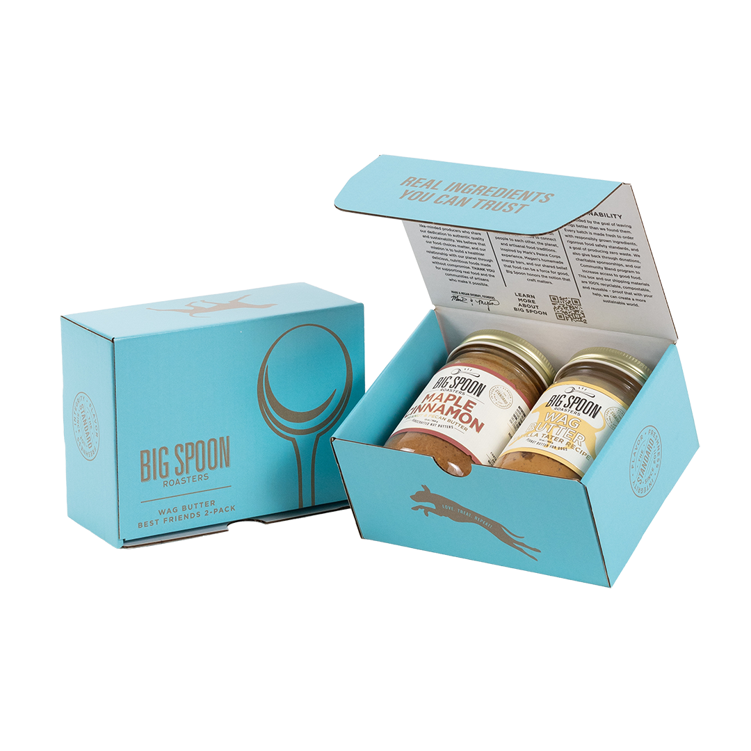 Light blue gift box with two jars of Big Spoon Roasters nut butter next to a closed blue gift box