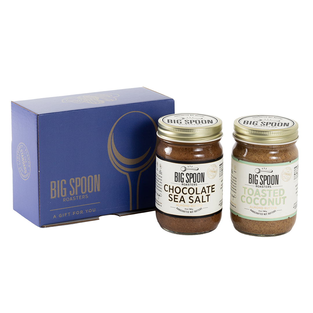 Two jars of Big Spoon Roasters nut butter next to a blue box