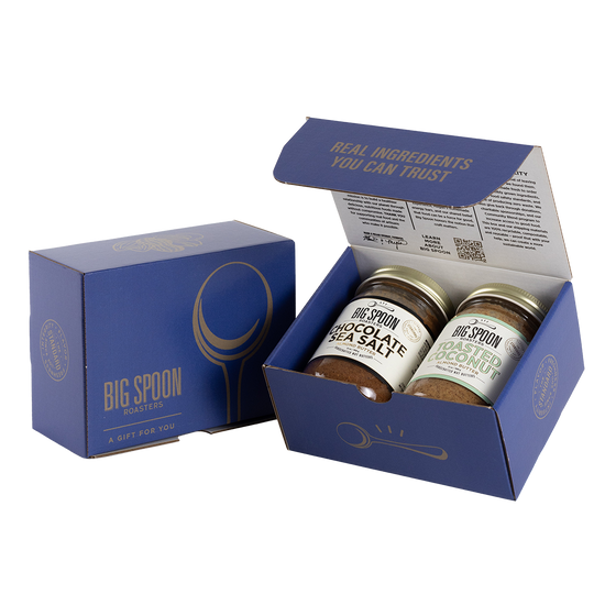 Blue gift box with two jars of Big Spoon Roasters nut butter next to a closed blue gift box