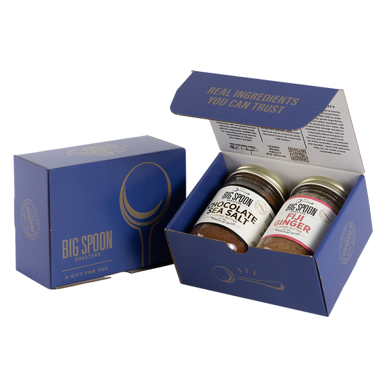 Blue gift box with two jars of Big Spoon Roasters nut butter next to a closed blue gift box