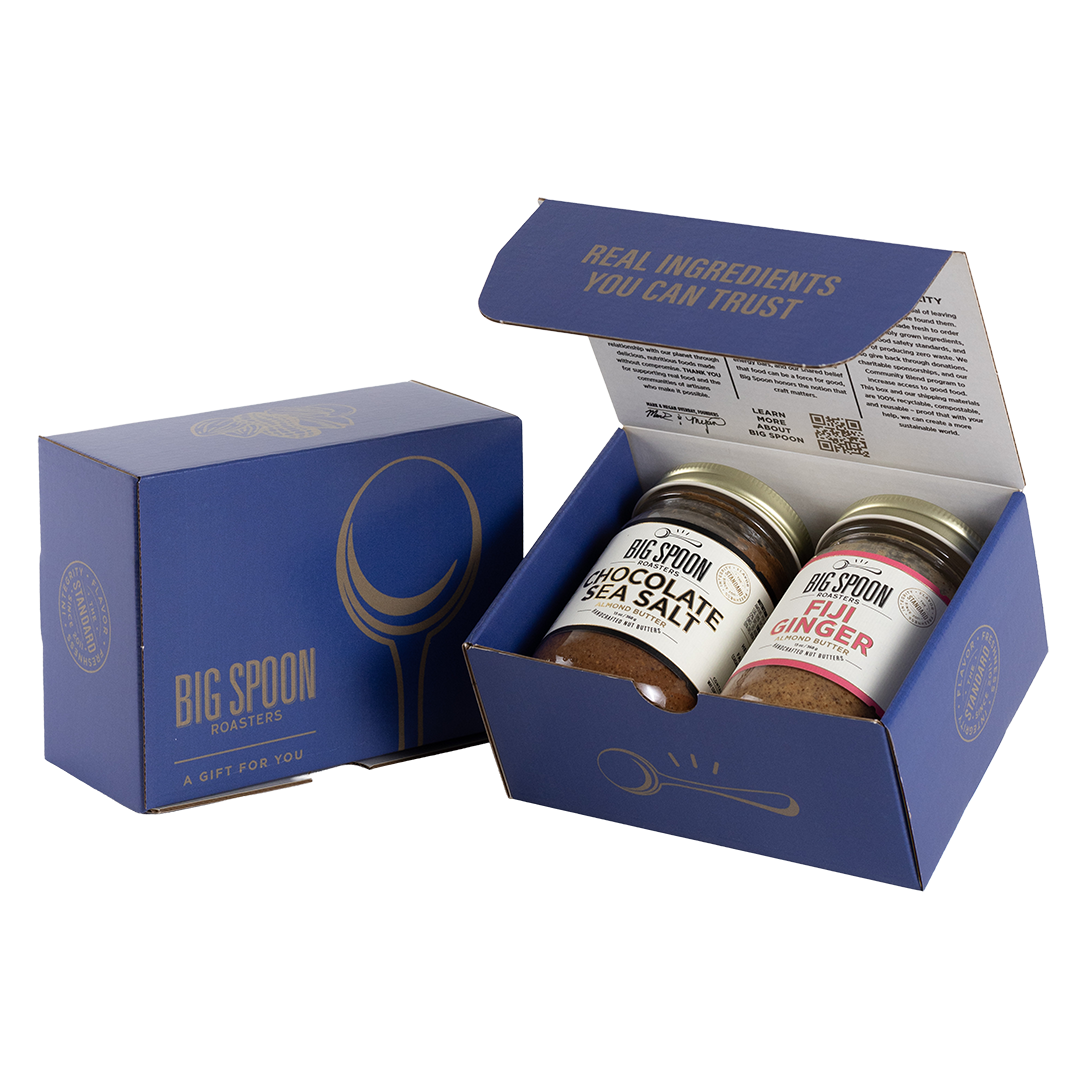 Blue gift box with two jars of Big Spoon Roasters nut butter next to a closed blue gift box
