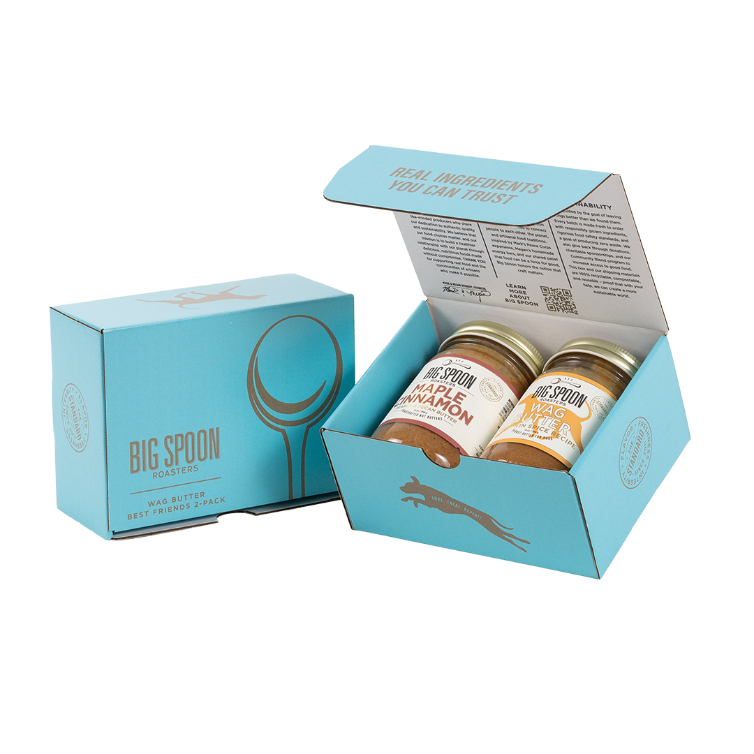 Light blue gift box with two jars of Big Spoon Roasters nut butter next to a closed blue gift box
