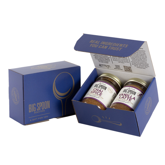 Blue gift box with two jars of Big Spoon Roasters nut butter next to a closed blue gift box