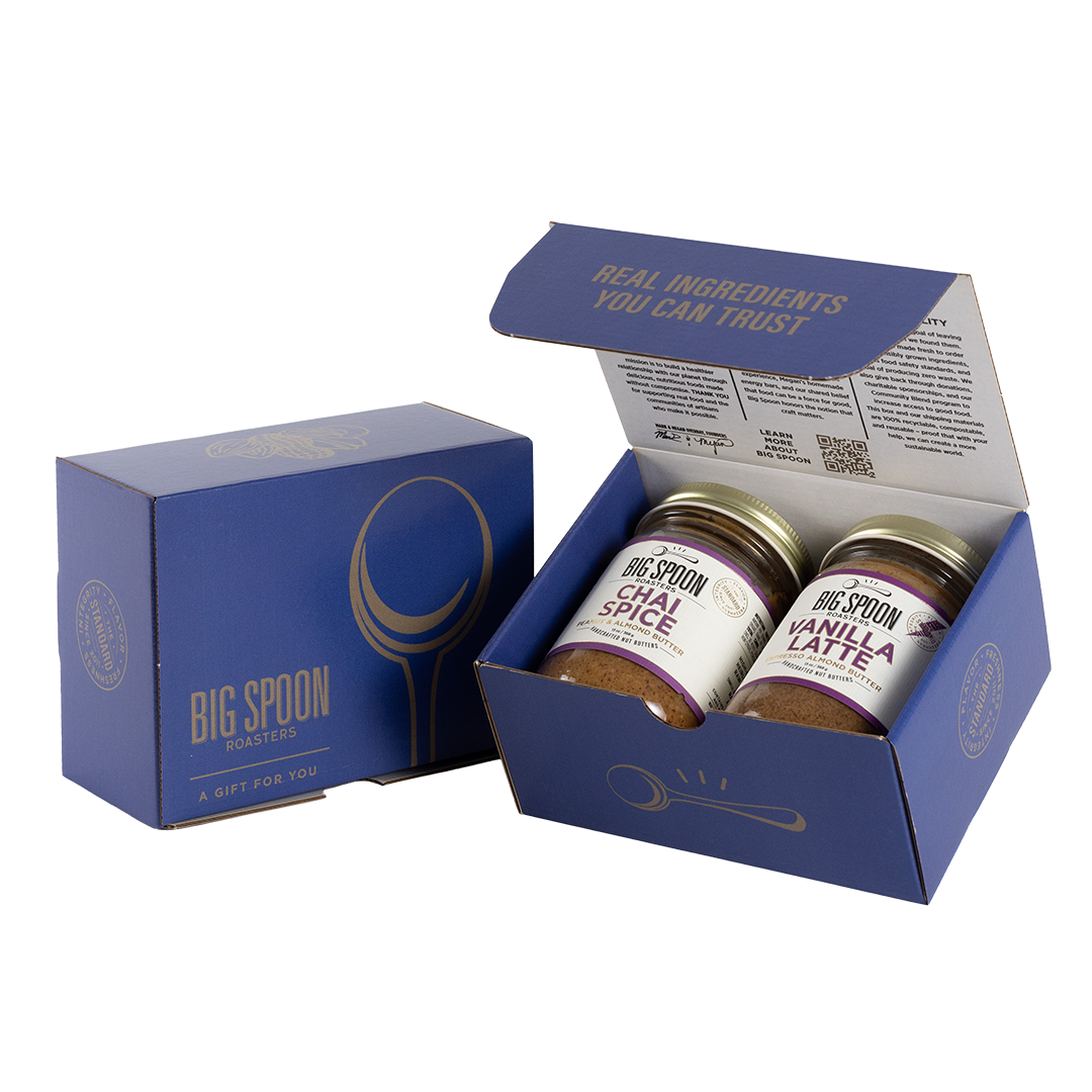 Blue gift box with two jars of Big Spoon Roasters nut butter next to a closed blue gift box