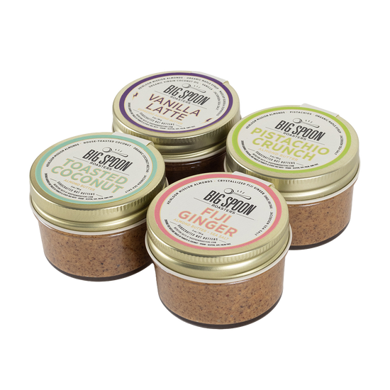 Four jars of Big Spoon almond butters with visible labels on a white background