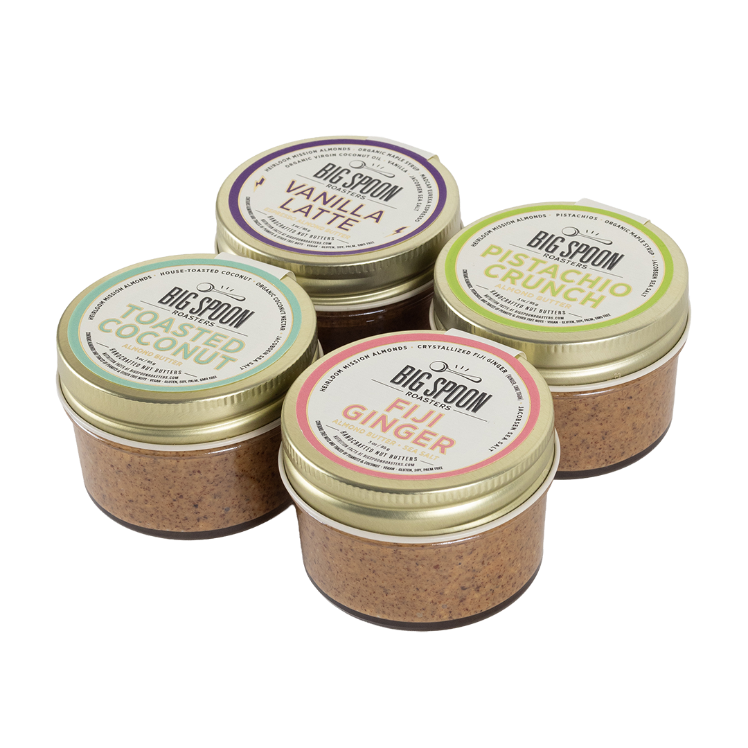 Four jars of Big Spoon almond butters with visible labels on a white background
