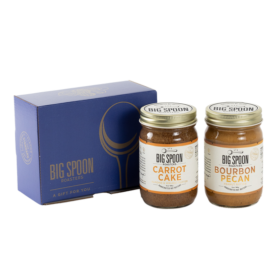 Two jars of Big Spoon Roasters nut butter next to a blue box