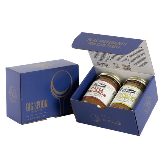 Blue gift box with two jars of Big Spoon Roasters nut butter next to a closed blue gift box