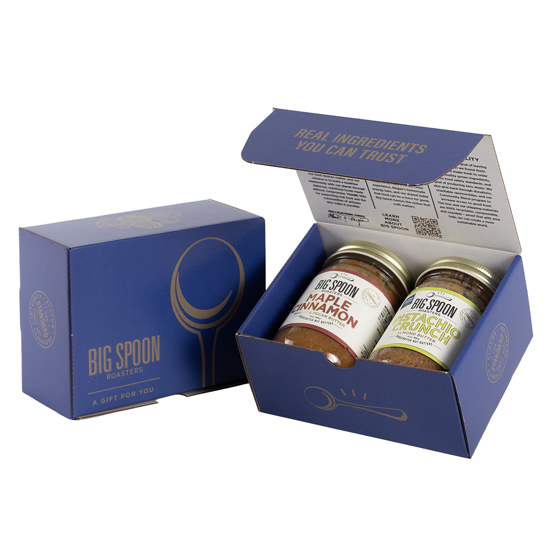 Blue gift box with two jars of Big Spoon Roasters nut butter next to a closed blue gift box