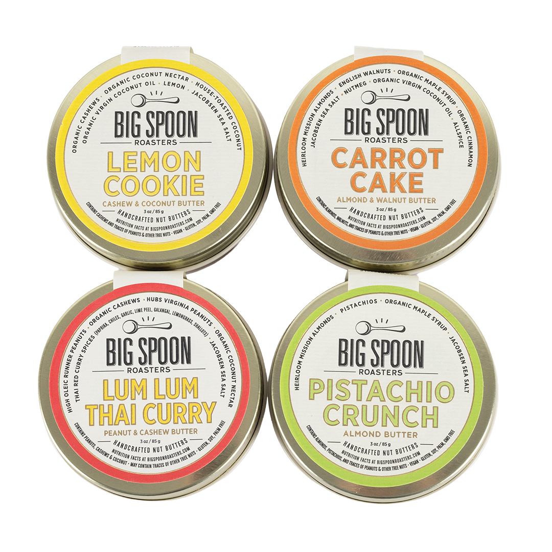 Four tins of Big Spoon Roasters nut butters on a white background.
