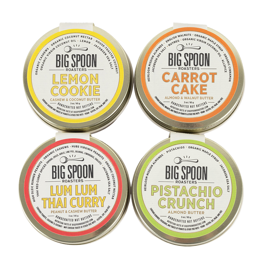 Four tins of Big Spoon Roasters nut butters on a white background.
