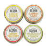 Four tins of Big Spoon Roasters nut butters on a white background.