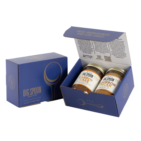 Blue gift box with two jars of Big Spoon Roasters nut butter next to a closed blue gift box