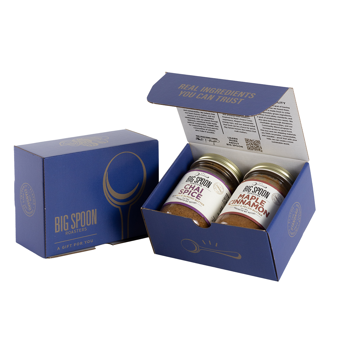 Blue gift box with two jars of Big Spoon Roasters nut butter next to a closed blue gift box