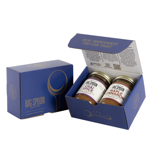 Blue gift box with two jars of Big Spoon Roasters nut butter next to a closed blue gift box