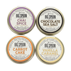 Four tins of Big Spoon Roasters nut butter on a white background