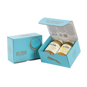 Light blue gift box with two jars of Big Spoon Roasters nut butter next to a closed blue gift box