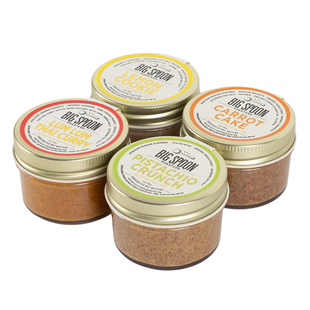 Four jars of Big Spoon nut butters on a white background